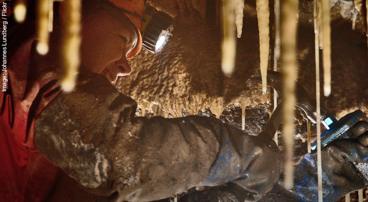 PhD student sampling cave stalactites to study past climates